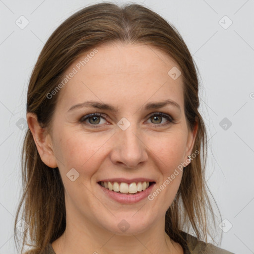 Joyful white adult female with medium  brown hair and grey eyes