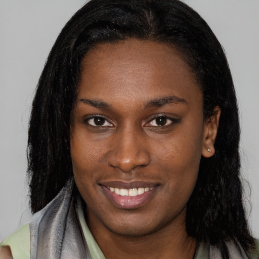 Joyful latino young-adult female with long  black hair and brown eyes