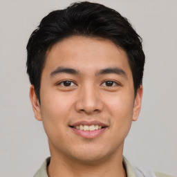 Joyful asian young-adult male with short  brown hair and brown eyes