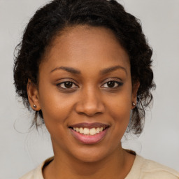 Joyful black young-adult female with medium  brown hair and brown eyes