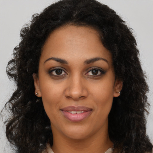 Joyful latino young-adult female with long  brown hair and brown eyes