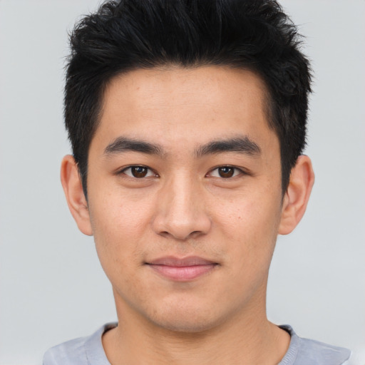 Joyful asian young-adult male with short  black hair and brown eyes