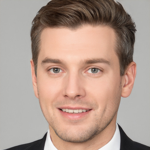 Joyful white young-adult male with short  brown hair and brown eyes