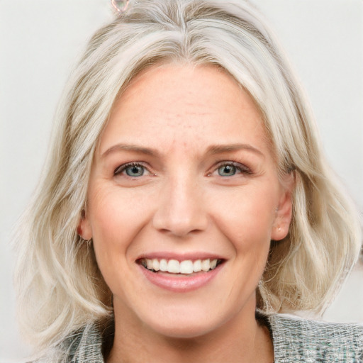 Joyful white young-adult female with medium  blond hair and blue eyes