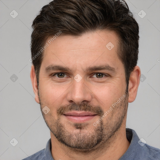 Joyful white adult male with short  brown hair and brown eyes