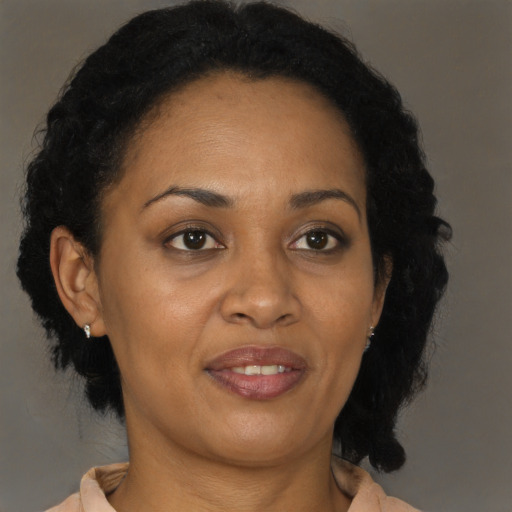 Joyful black adult female with medium  brown hair and brown eyes