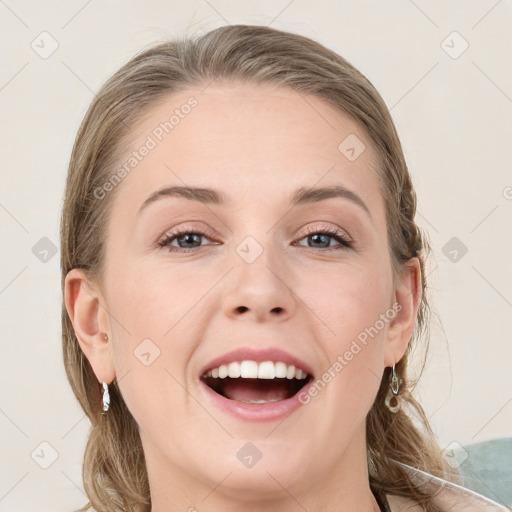 Joyful white young-adult female with medium  brown hair and grey eyes