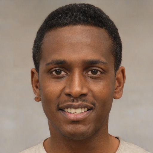 Joyful black young-adult male with short  black hair and brown eyes