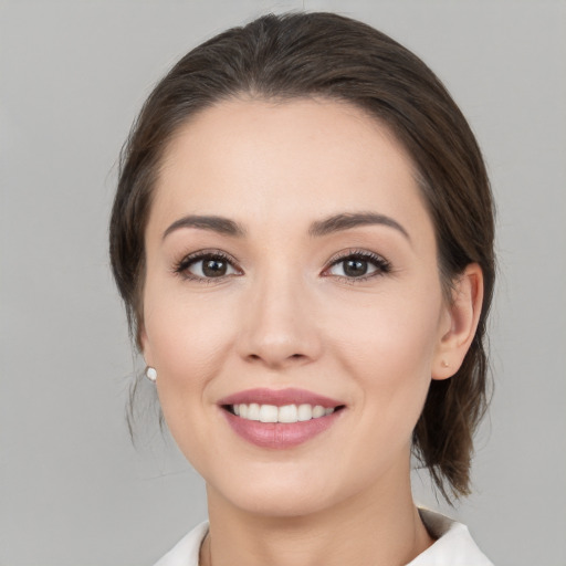 Joyful white young-adult female with medium  brown hair and brown eyes