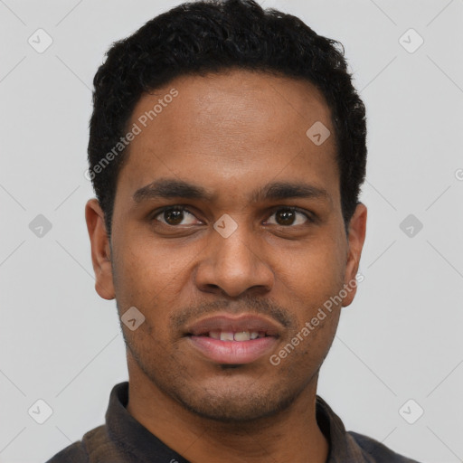 Joyful black young-adult male with short  black hair and brown eyes