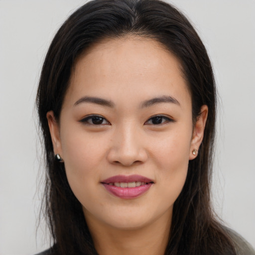 Joyful asian young-adult female with long  brown hair and brown eyes