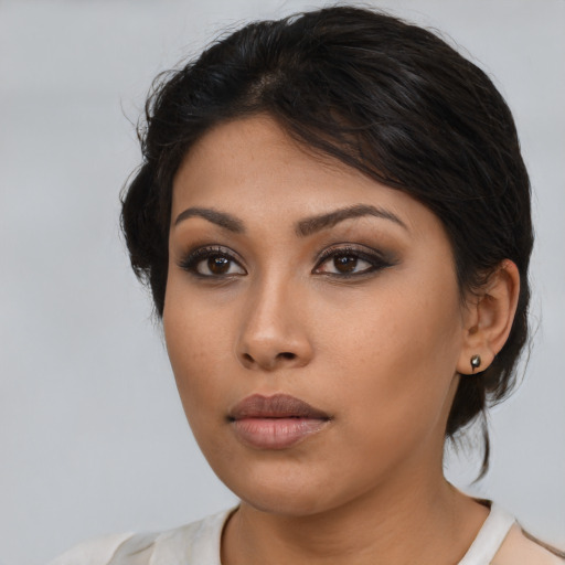 Neutral latino young-adult female with medium  brown hair and brown eyes