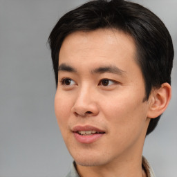 Joyful asian young-adult male with short  black hair and brown eyes
