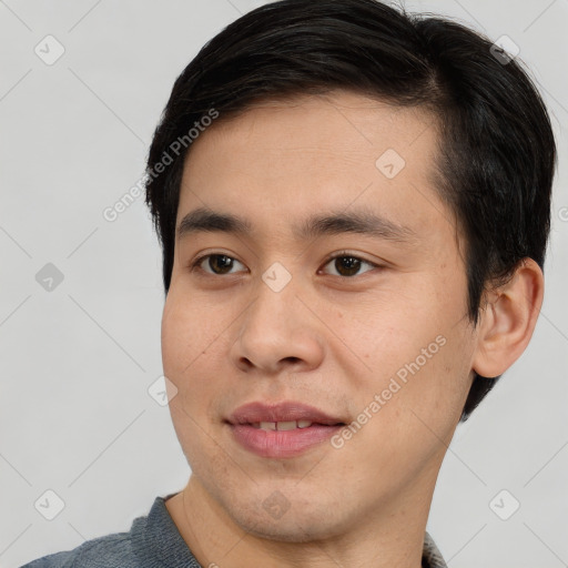 Joyful asian young-adult male with short  black hair and brown eyes