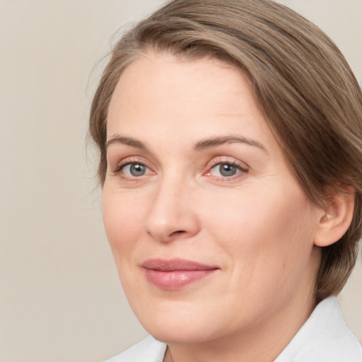 Joyful white adult female with medium  brown hair and grey eyes