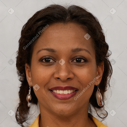 Joyful black young-adult female with long  brown hair and brown eyes