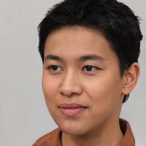 Joyful asian young-adult male with short  brown hair and brown eyes