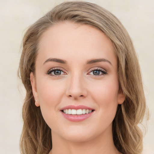 Joyful white young-adult female with long  brown hair and green eyes