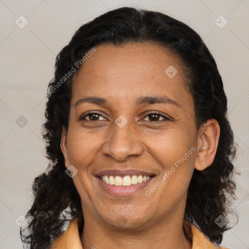 Joyful black adult female with medium  brown hair and brown eyes