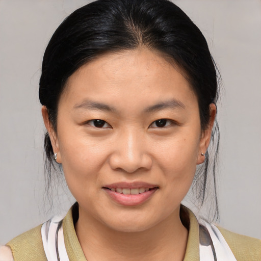 Joyful asian young-adult female with medium  brown hair and brown eyes