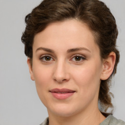 Joyful white young-adult female with medium  brown hair and green eyes