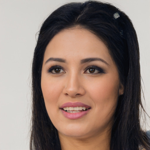 Joyful latino young-adult female with long  black hair and brown eyes