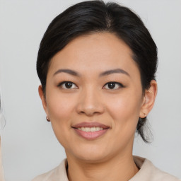 Joyful asian young-adult female with medium  brown hair and brown eyes