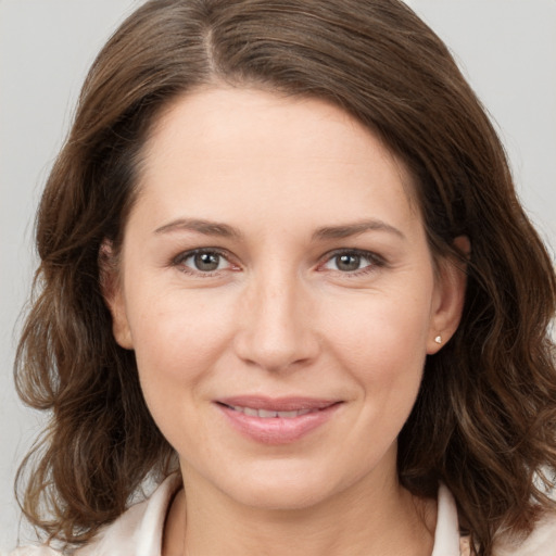 Joyful white young-adult female with medium  brown hair and brown eyes