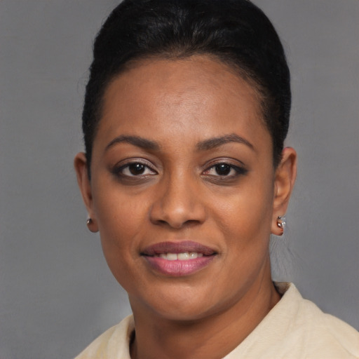 Joyful black young-adult female with short  brown hair and brown eyes
