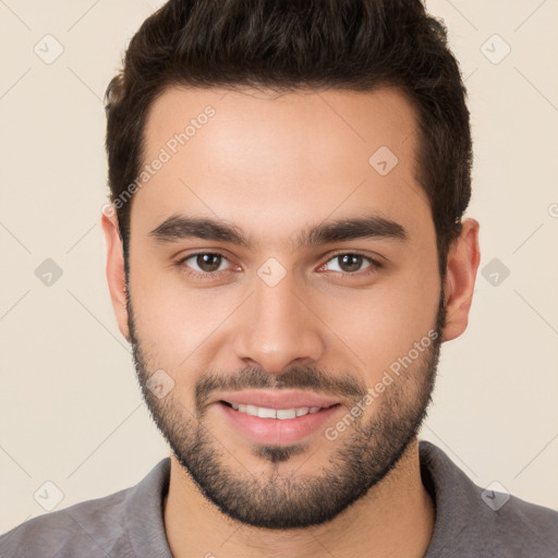 Joyful white young-adult male with short  brown hair and brown eyes