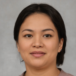 Joyful asian young-adult female with medium  brown hair and brown eyes