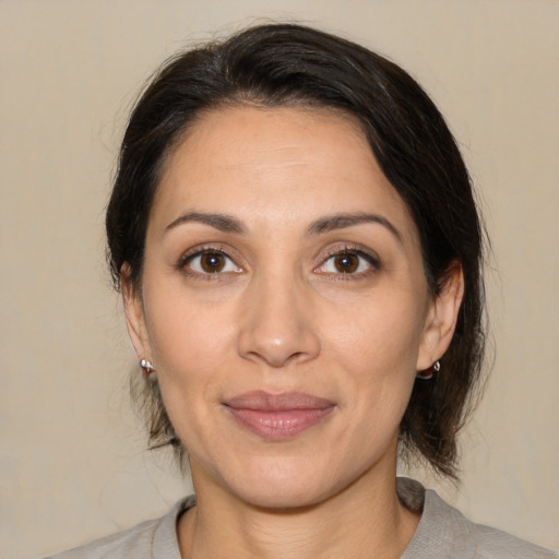 Joyful white adult female with medium  brown hair and brown eyes