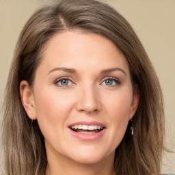 Joyful white young-adult female with long  brown hair and green eyes