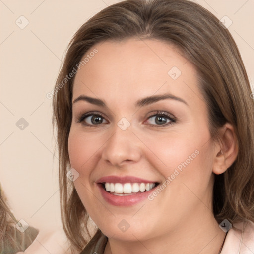 Joyful white young-adult female with long  brown hair and brown eyes