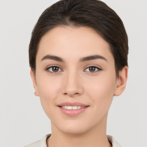 Joyful white young-adult female with short  brown hair and brown eyes