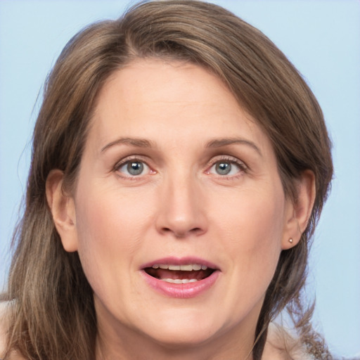 Joyful white adult female with medium  brown hair and grey eyes