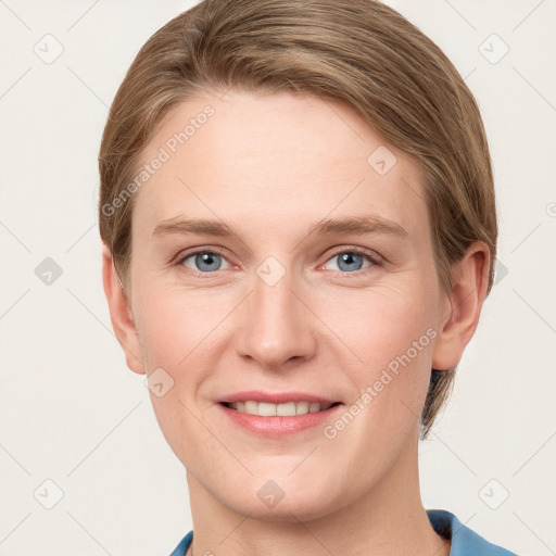 Joyful white young-adult female with short  brown hair and grey eyes