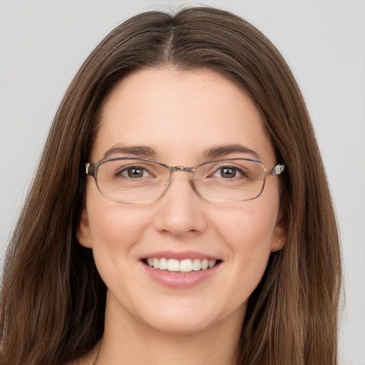 Joyful white young-adult female with long  brown hair and grey eyes