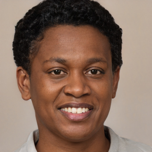 Joyful black young-adult male with short  brown hair and brown eyes