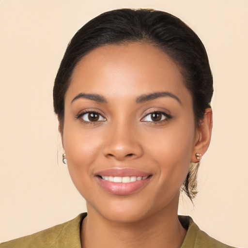 Joyful latino young-adult female with medium  brown hair and brown eyes