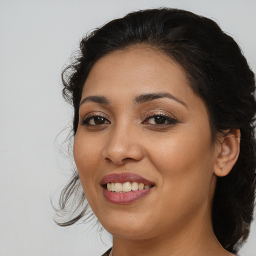 Joyful latino young-adult female with medium  brown hair and brown eyes