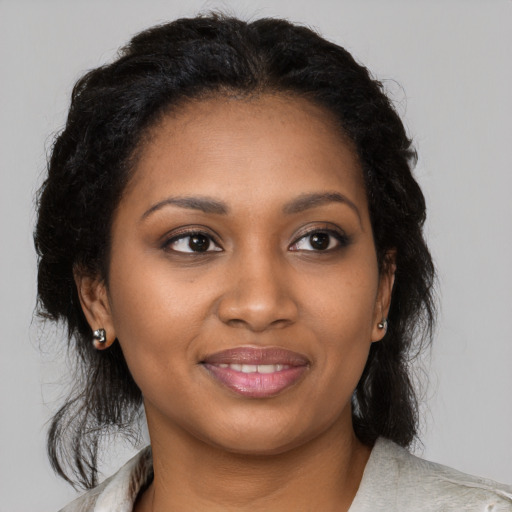 Joyful black young-adult female with medium  brown hair and brown eyes