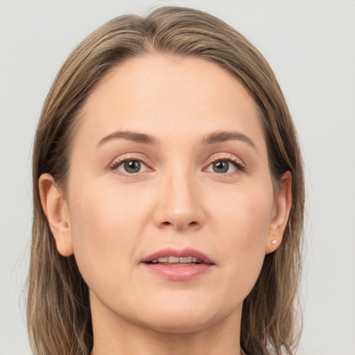 Joyful white young-adult female with long  brown hair and grey eyes