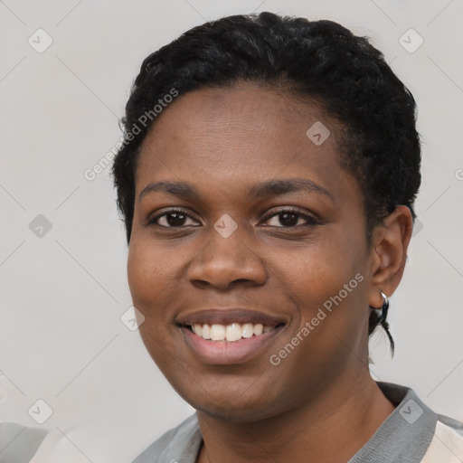 Joyful black young-adult female with short  black hair and brown eyes