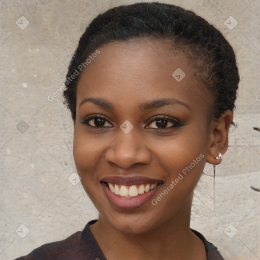 Joyful black young-adult female with short  black hair and brown eyes