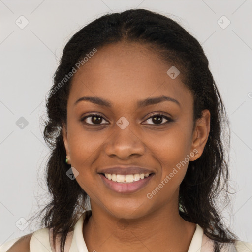 Joyful black young-adult female with long  brown hair and brown eyes