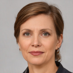 Joyful white adult female with medium  brown hair and grey eyes