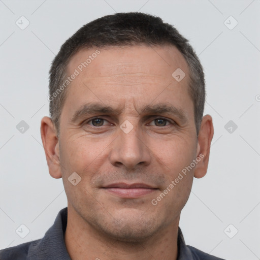 Joyful white adult male with short  brown hair and brown eyes