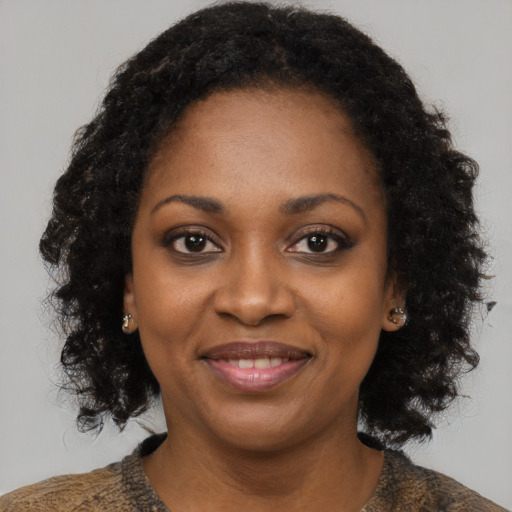 Joyful black young-adult female with medium  brown hair and brown eyes