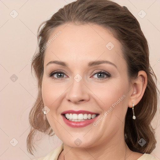 Joyful white young-adult female with medium  brown hair and grey eyes